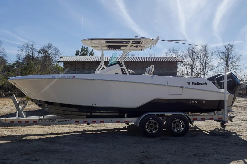 The Image of 2019 Wellcraft 262 Fisherman boat on trailer, parked outdoors. - 0