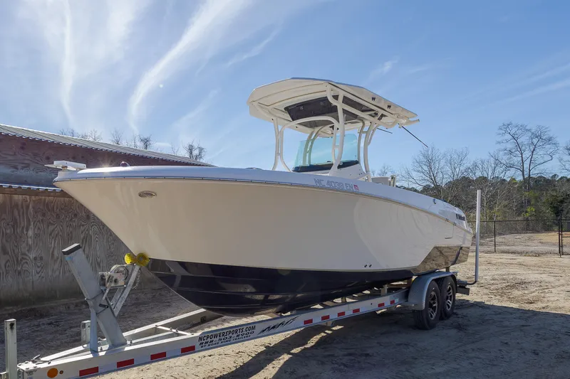 Slide: The Image of 2019 Wellcraft 262 Fisherman boat on trailer under clear sky. - 4
