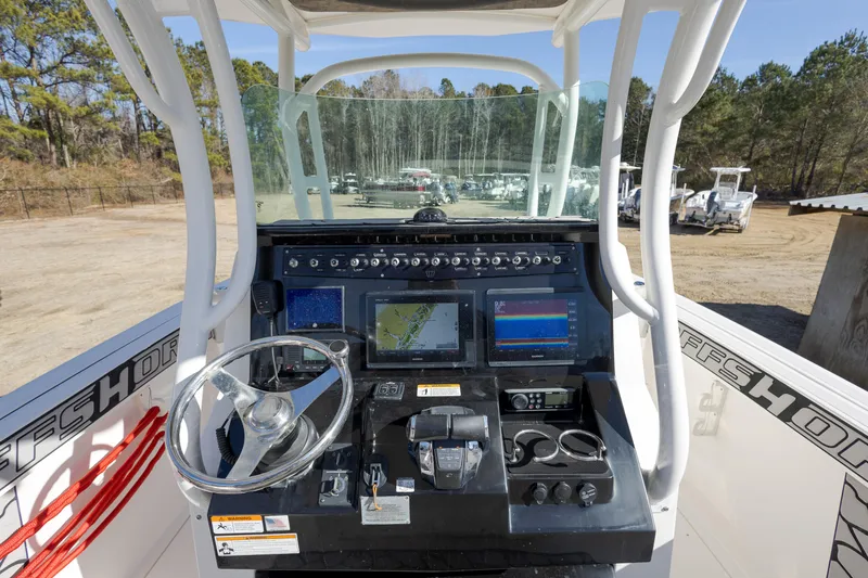 Slide: The Image of 2019 Wellcraft 262 Fisherman boat console with navigation screens and controls. - 9