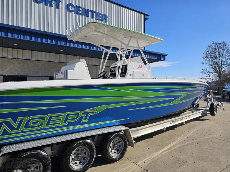Slide: The Image of 2014 Concept 36' CC boat with blue and green design on a trailer outside a building. - 10