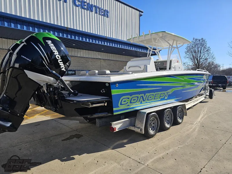 Slide: The Image of 2014 Concept 36' CC boat with Mercury engine on a trailer, parked outside a building. - 12