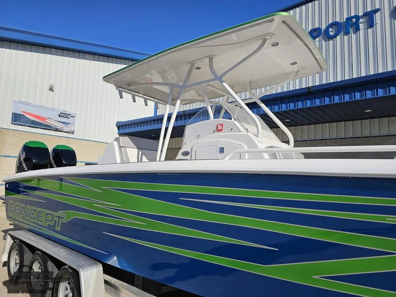 Slide: The Image of 2014 Concept 36' CC boat with blue and green design, parked outside a building. - 18