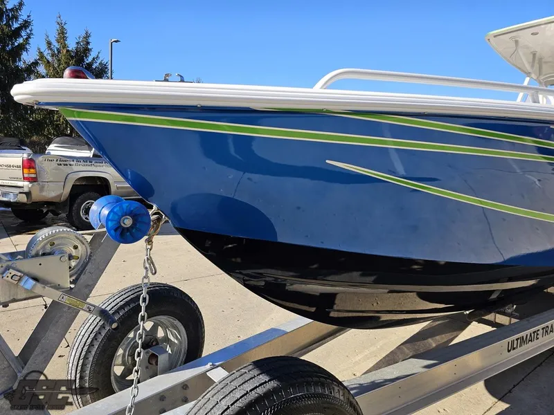 Slide: The Image of 2014 Concept 36' CC boat on trailer, blue hull with green accents, parked outdoors. - 24