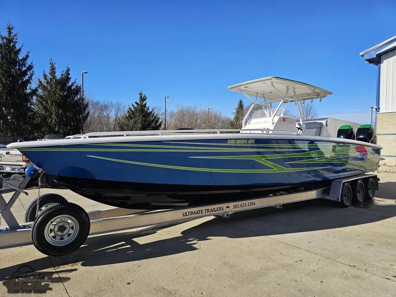 Slide: The Image of 2014 Concept 36' CC boat on trailer, blue and green design, parked outdoors. - 25