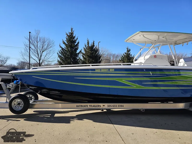 Slide: The Image of 2014 Concept 36' CC boat on trailer, blue and green design, parked outdoors. - 27