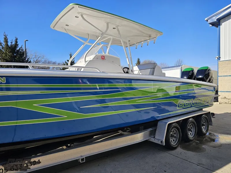 Slide: The Image of 2014 Concept 36' CC boat with vibrant blue and green design on a trailer. - 28