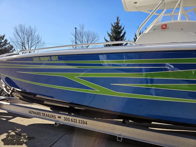 Slide: The Image of 2014 Concept 36' CC boat with blue and green design on a trailer. - 30