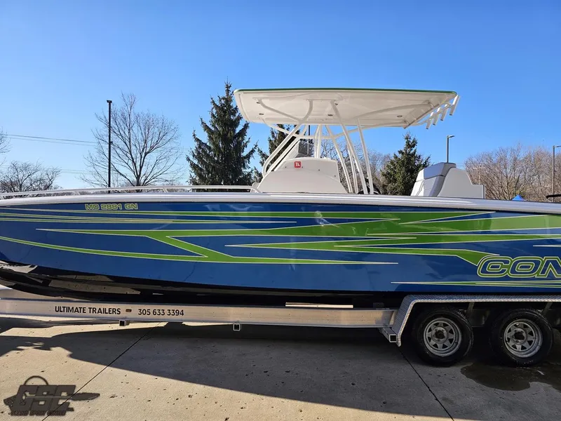 Slide: The Image of 2014 Concept 36' CC boat on trailer, blue and green design, sunny day. - 31