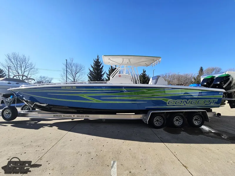 Slide: The Image of 2014 Concept 36' CC boat on trailer, blue and green design, parked outdoors. - 32