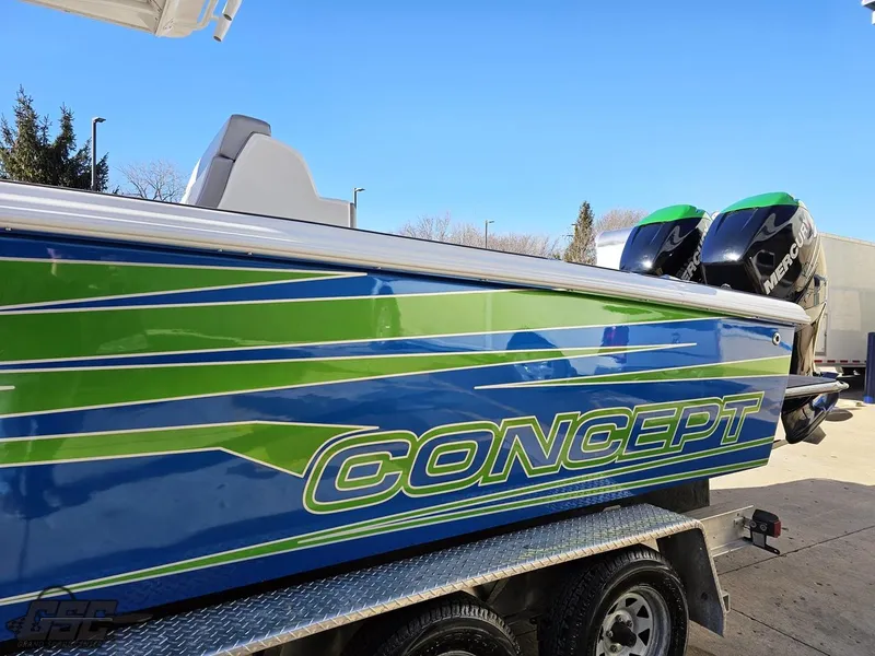 Slide: The Image of 2014 Concept 36' CC boat with vibrant blue and green design on a trailer. - 33