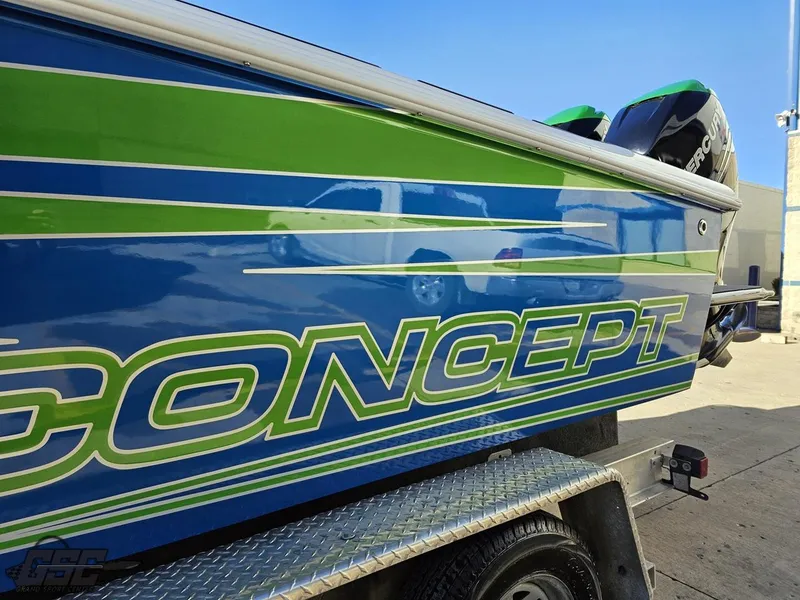 Slide: The Image of 2014 Concept 36' CC boat with vibrant blue and green design on trailer. - 34