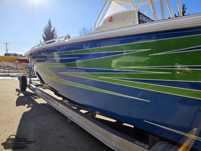 Slide: The Image of 2014 Concept 36' CC boat with blue and green design on a trailer. - 35