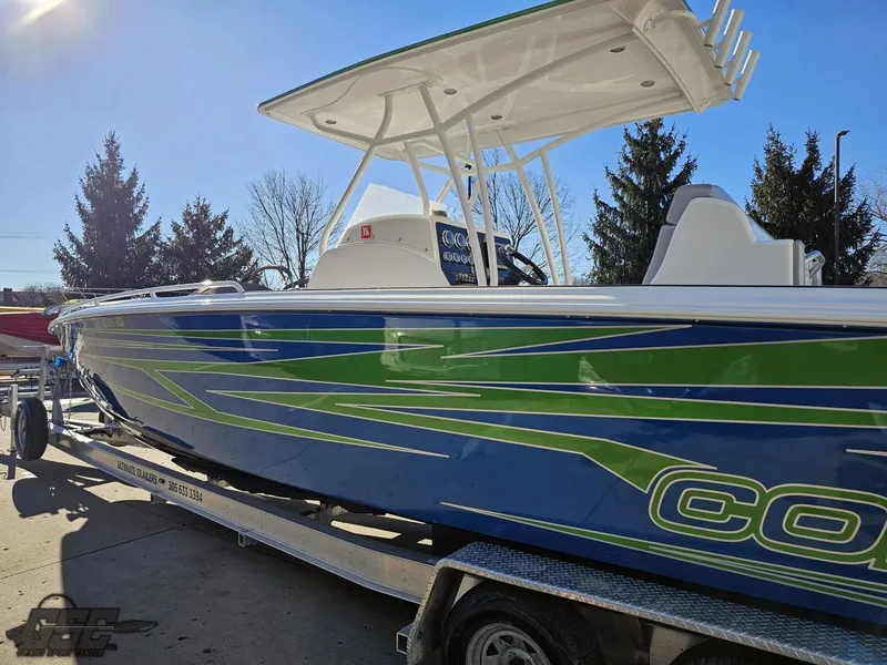 Slide: The Image of 2014 Concept 36' CC boat with blue and green design on a trailer. - 36