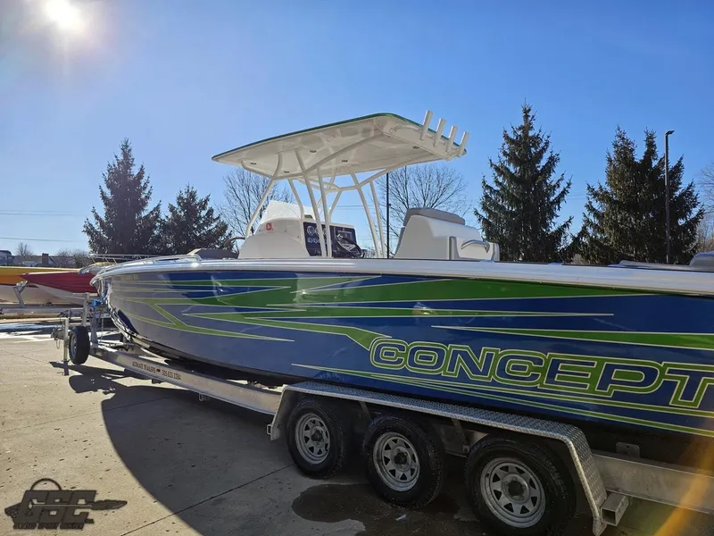 Slide: The Image of Concept 36' CC 2014 boat on trailer, vibrant blue and green design, sunny day. - 37