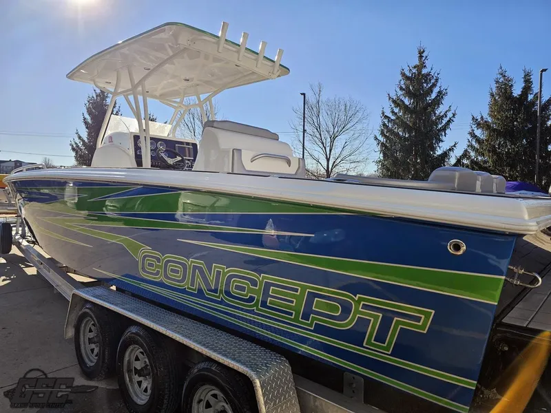 Slide: The Image of 2014 Concept 36' CC boat with vibrant blue and green design on a trailer. - 38