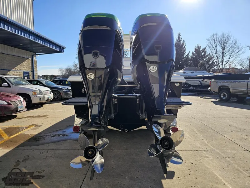 Slide: The Image of Twin outboard motors on a 2014 Concept 36' CC boat in a sunny parking lot. - 44