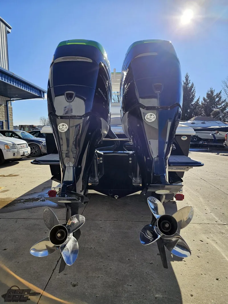 Slide: The Image of Twin outboard motors on a 2014 Concept 36' CC boat, parked outdoors. - 45