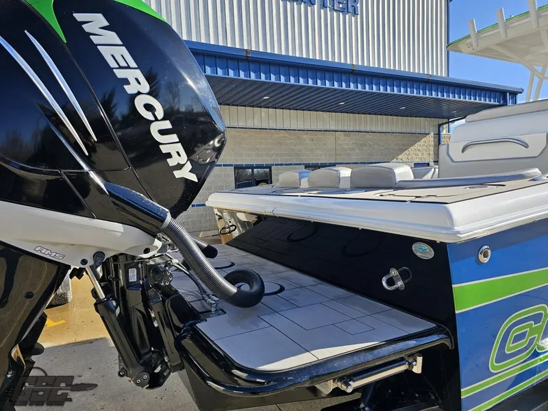 Slide: The Image of Concept 36' CC 2014 boat with Mercury engine, docked near a building. - 49