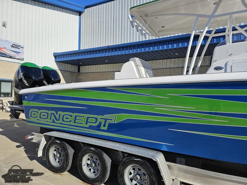 Slide: The Image of 2014 Concept 36' CC boat with vibrant blue and green design on a trailer. - 6