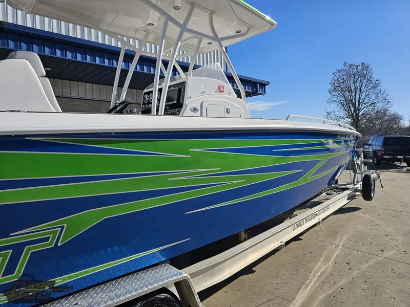Slide: The Image of 2014 Concept 36' CC boat with vibrant blue and green design on a trailer. - 9