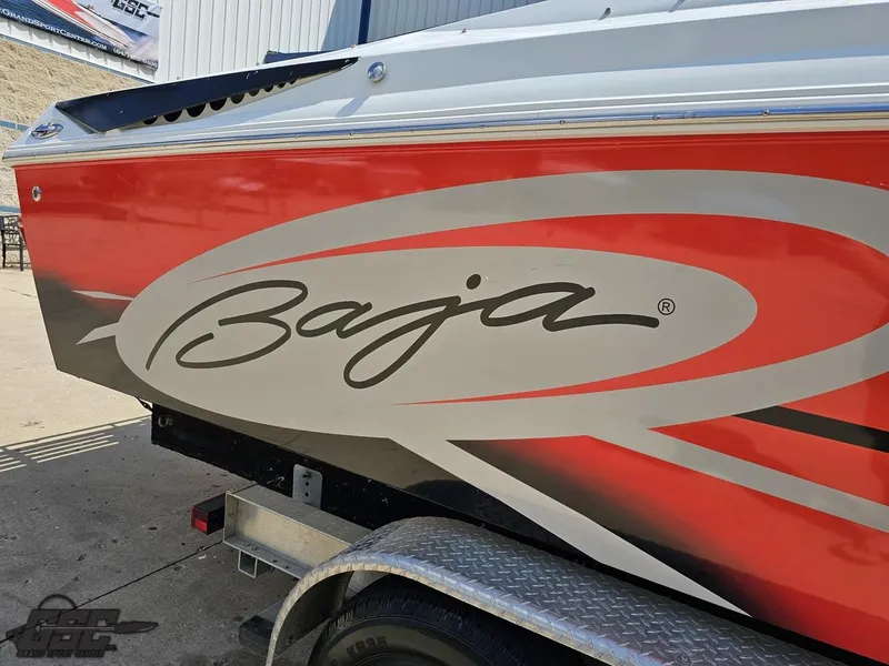 Slide: The Image of 2007 Baja 26 Outlaw boat with red and gray graphics on a trailer. - 11
