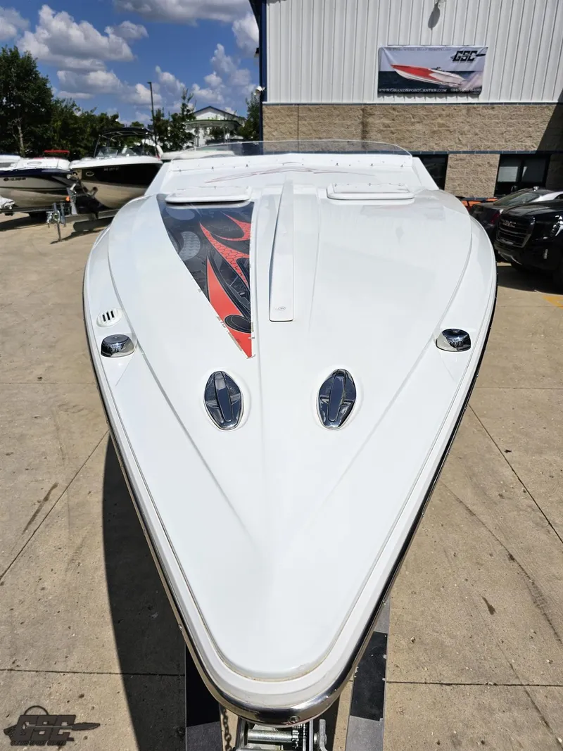 Slide: The Image of 2007 Baja 26 Outlaw boat with sleek design, parked outdoors under a clear sky. - 19