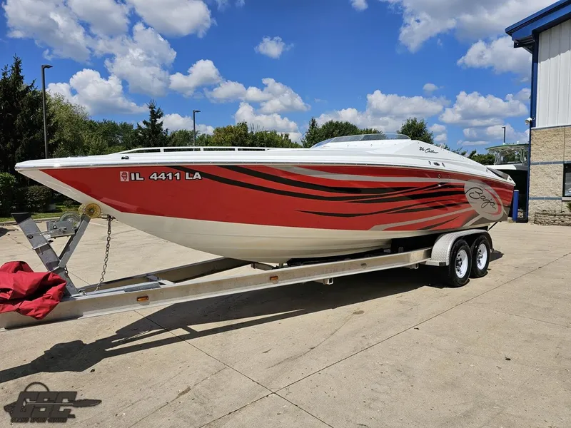 Slide: The Image of 2007 Baja 26 Outlaw boat on trailer, red and white design, parked outdoors. - 21