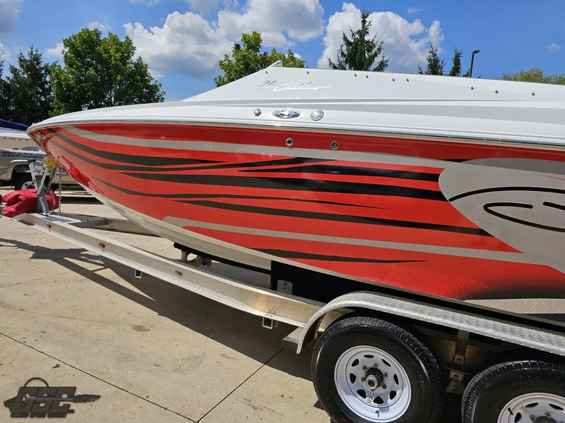 Slide: The Image of 2007 Baja 26 Outlaw boat with red and black stripes on a trailer. - 27