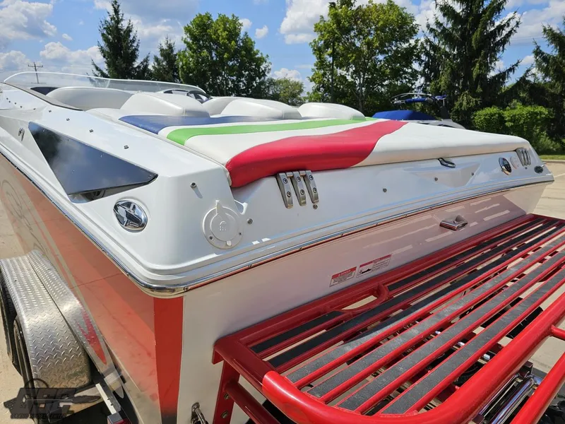 Slide: The Image of 2007 Baja 26 Outlaw boat with colorful seating and red swim platform. - 31