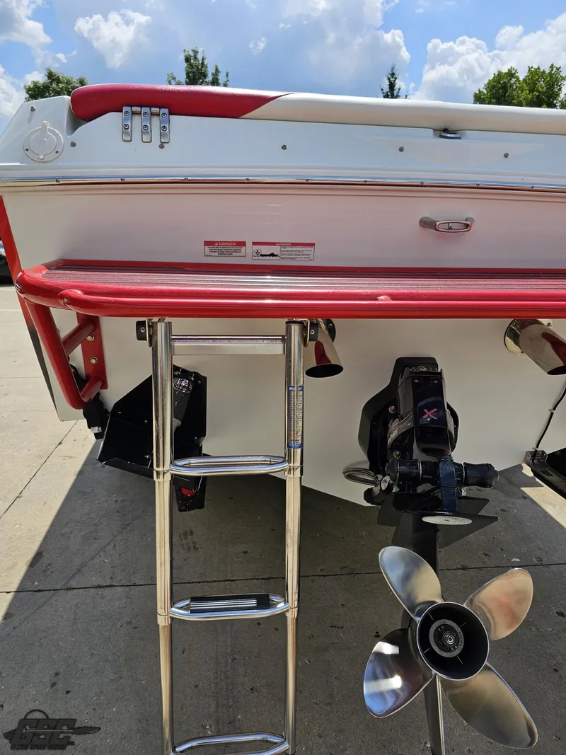 Slide: The Image of 2007 Baja 26 Outlaw boat stern with ladder and propeller, parked outdoors. - 36