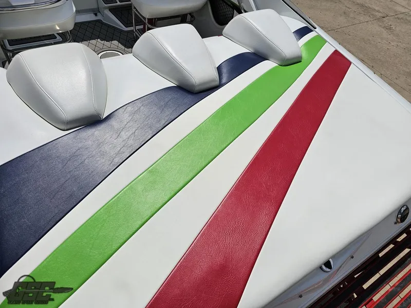 Slide: The Image of 2007 Baja 26 Outlaw boat interior with colorful striped upholstery design. - 38
