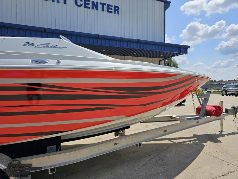 Slide: The Image of 2007 Baja 26 Outlaw boat with red and black stripes on a trailer. - 4