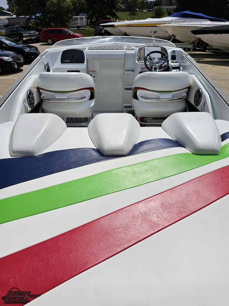 Slide: The Image of 2007 Baja 26 Outlaw boat interior with colorful seating and dashboard. - 40