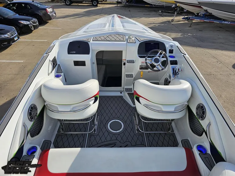 Slide: The Image of 2007 Baja 26 Outlaw boat interior with white seating and modern dashboard. - 44
