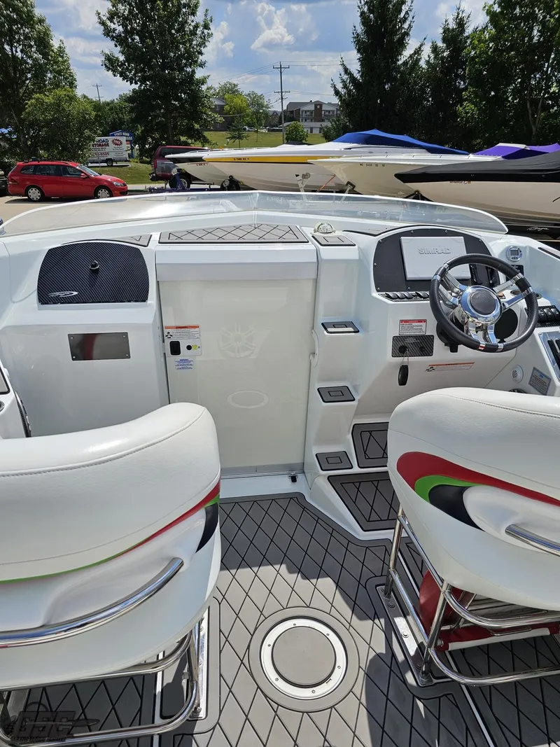 Slide: The Image of 2007 Baja 26 Outlaw boat cockpit with white seating and modern dashboard. - 48