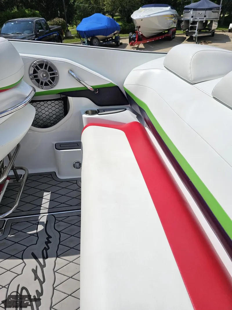 Slide: The Image of 2007 Baja 26 Outlaw boat interior with white, red, and green seating. - 49