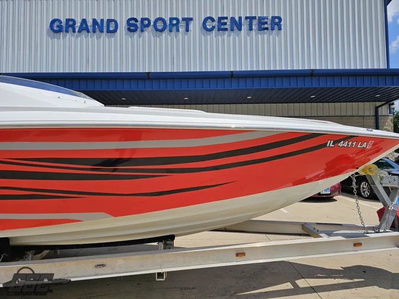 Slide: The Image of 2007 Baja 26 Outlaw boat with red and black design at Grand Sport Center. - 6