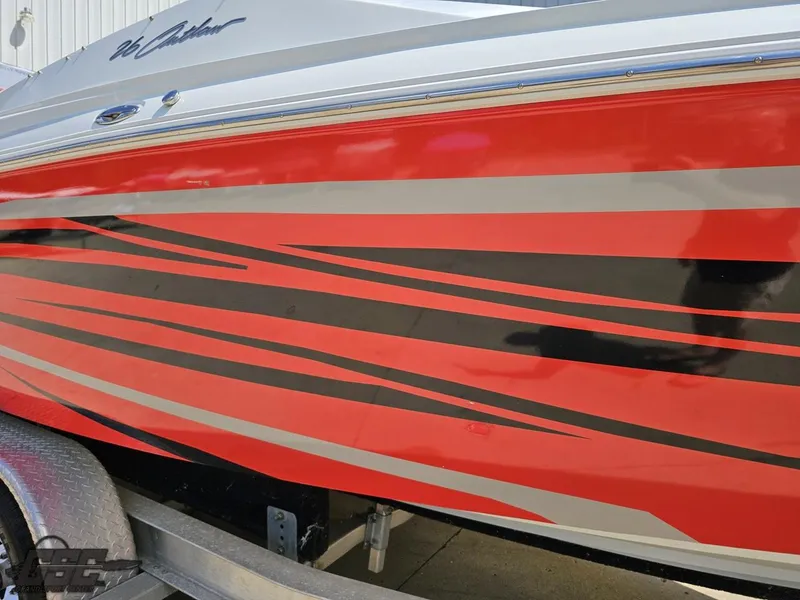 Slide: The Image of 2007 Baja 26 Outlaw boat with red and black striped design on the side. - 8