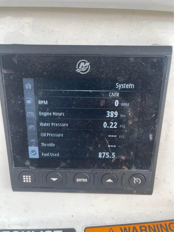 Slide: The Image of Dashboard display of a 2022 NauticStar 2302 Legacy boat showing engine metrics. - 13
