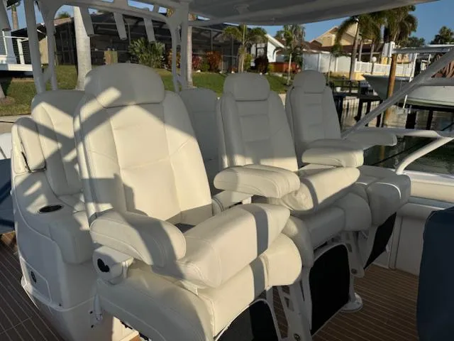 Slide: The Image of Luxurious seating on a 2016 Intrepid 475 Panacea boat, featuring plush white leather chairs. - 14