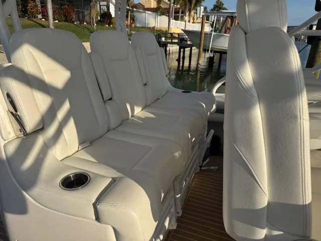 Slide: The Image of 2016 Intrepid 475 Panacea boat with luxurious white seating and cup holders. - 15