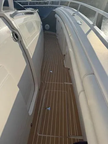 Slide: The Image of 2016 Intrepid 475 Panacea boat deck with sleek design and wood finish. - 16