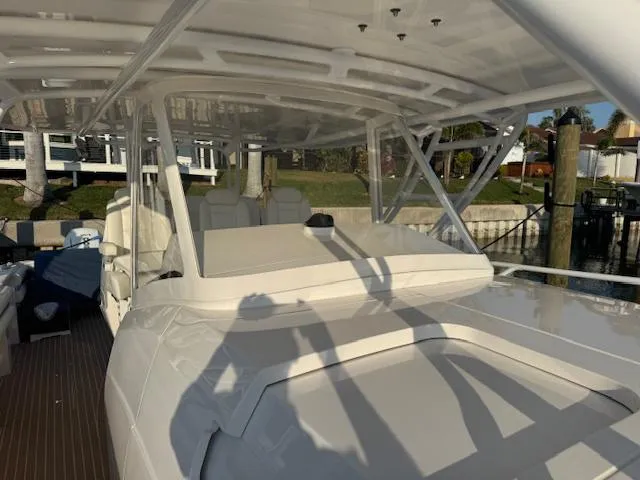 Slide: The Image of 2016 Intrepid 475 Panacea boat with sleek design, docked in a marina. - 17