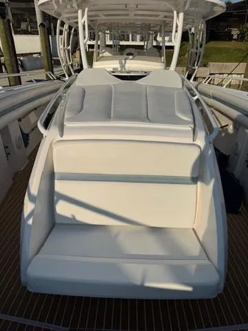 Slide: The Image of 2016 Intrepid 475 Panacea boat with cushioned seating and sleek design. - 18