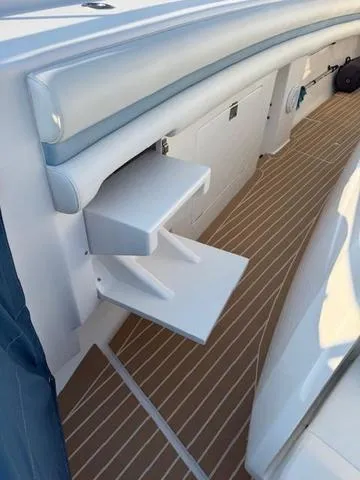 Slide: The Image of 2016 Intrepid 475 Panacea boat interior with foldable steps and teak flooring. - 20