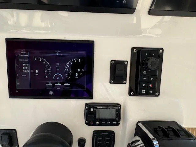 Slide: The Image of Control panel of a 2016 Intrepid 475 Panacea boat with digital displays and controls. - 27