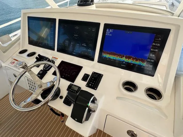 Slide: The Image of Control panel of 2016 Intrepid 475 Panacea with navigation screens and steering wheel. - 28