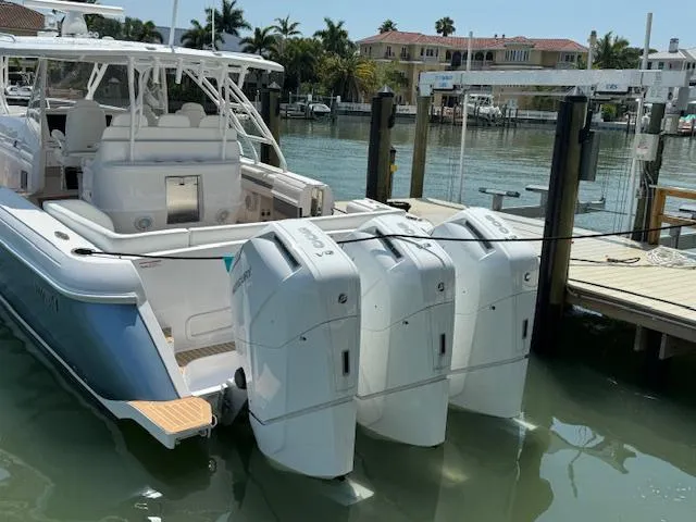 Slide: The Image of 2016 Intrepid Panacea boat docked with triple outboard engines in a marina setting. - 3