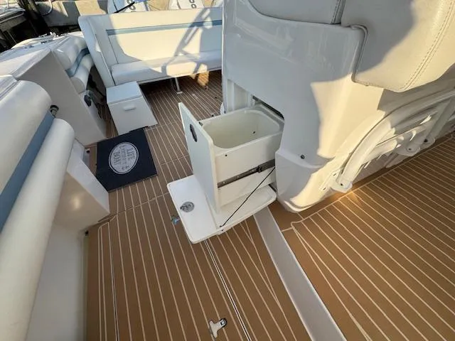 Slide: The Image of 2016 Intrepid 475 Panacea boat interior with wooden flooring and storage compartment. - 33