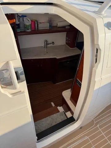 Slide: The Image of Interior view of 2016 Intrepid 475 Panacea boat, featuring a compact kitchenette. - 34